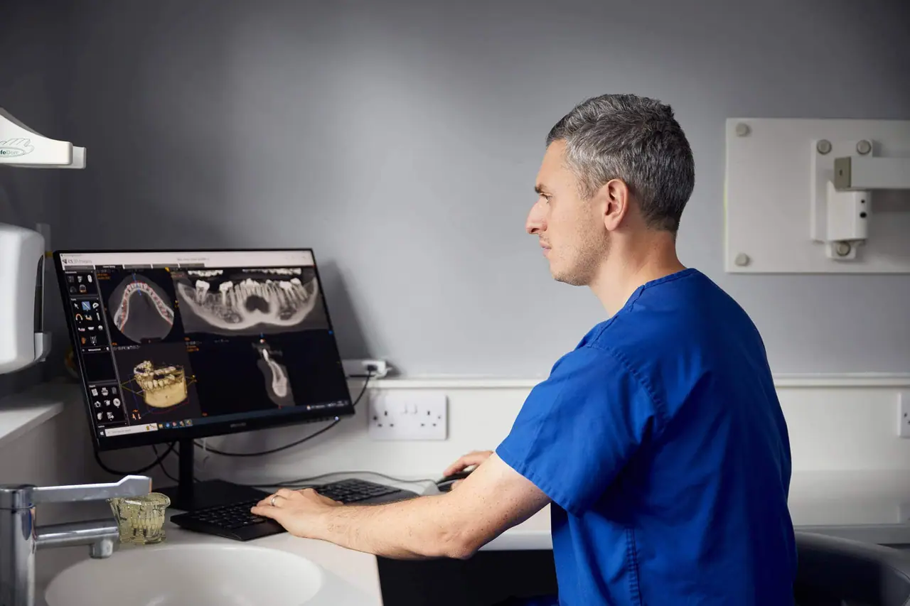 Dentist reviewing scan monitor