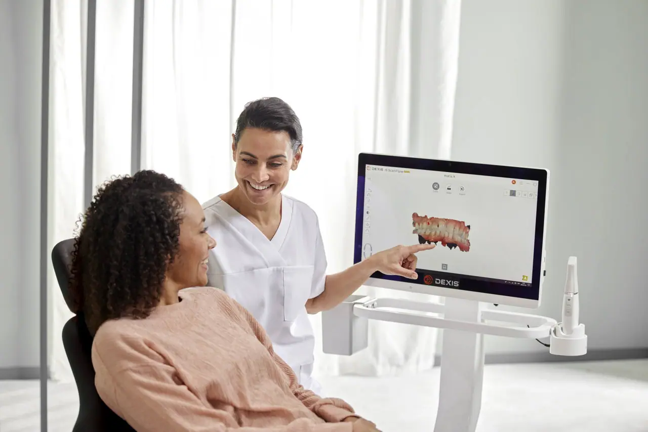Dentist showing patient screen